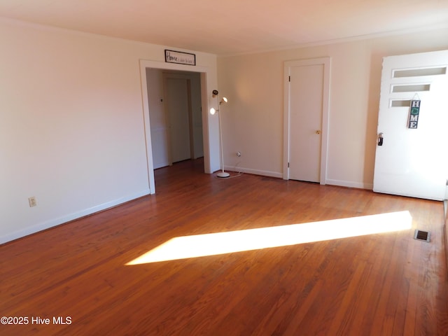 empty room with wood-type flooring