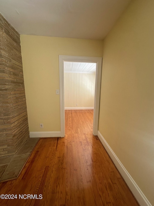 interior space with baseboards and wood finished floors