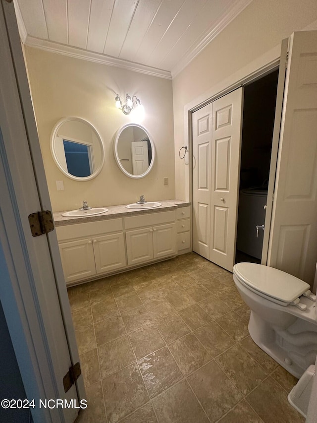 bathroom featuring ornamental molding, vanity, and toilet