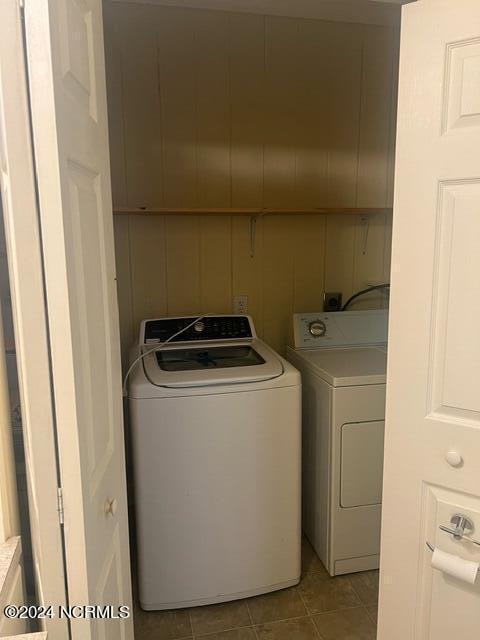 clothes washing area featuring light tile patterned floors and independent washer and dryer