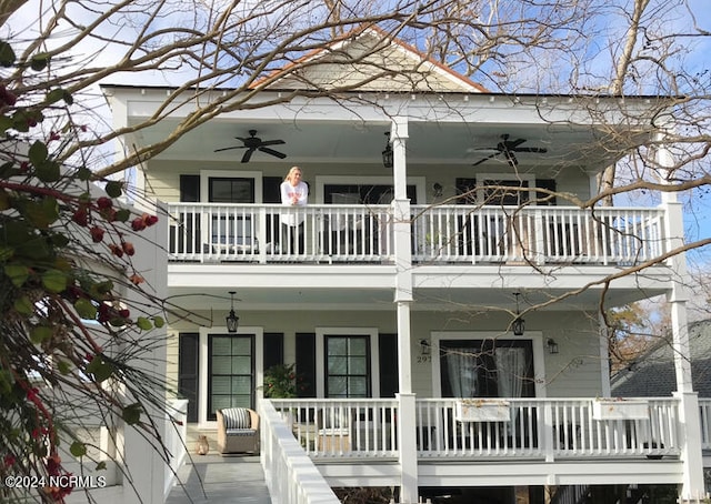 rear view of property featuring a balcony, ceiling fan, and covered porch