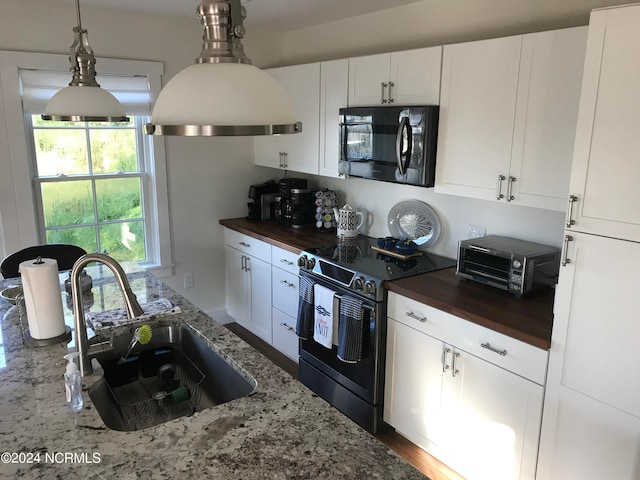 kitchen with white cabinets, stainless steel electric range oven, wood counters, and sink