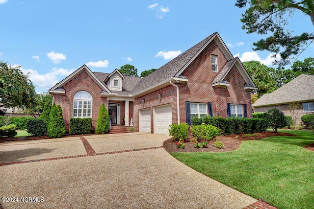 view of property featuring a garage and a front lawn