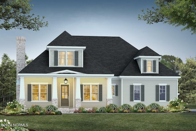 cape cod home featuring a porch, a front yard, and a chimney