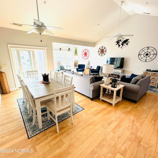 dining room featuring lofted ceiling, light wood-type flooring, and ceiling fan