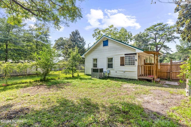 rear view of house with a yard