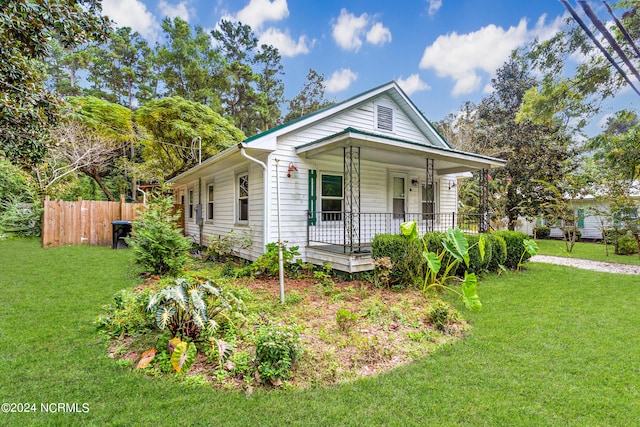 view of front of house with a front yard and a porch