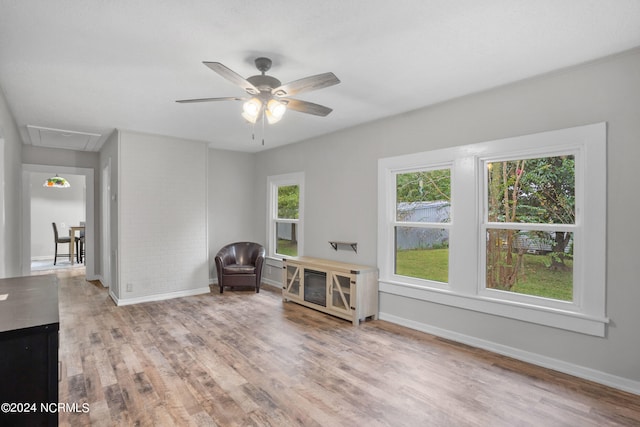 sitting room featuring ceiling fan and light wood-type flooring