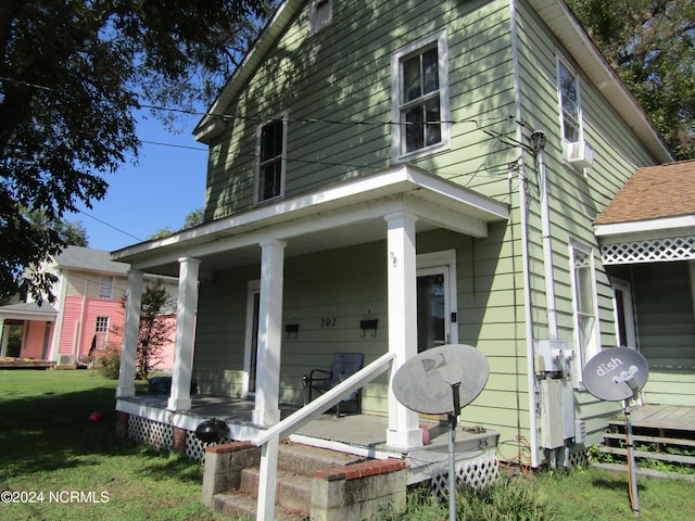 exterior space with a front yard and a porch