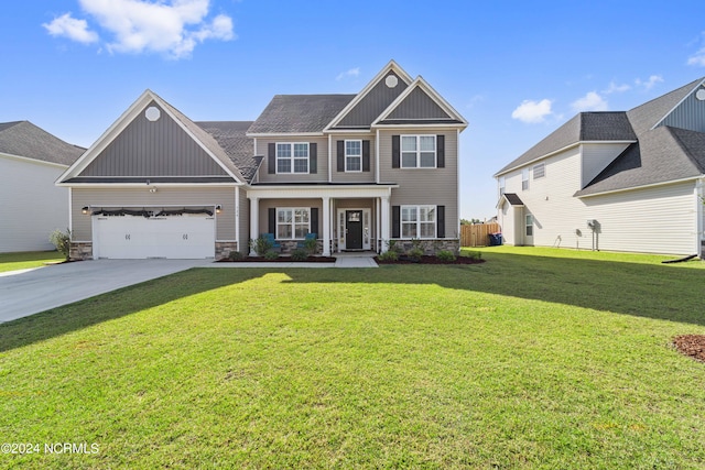 view of front of house with a garage and a front lawn