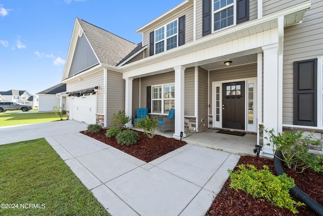 view of front of home featuring a porch and a garage