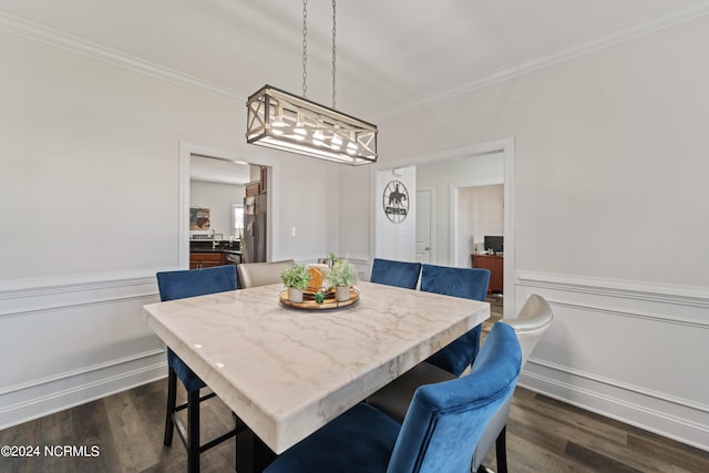 dining room featuring ornamental molding and dark wood-type flooring