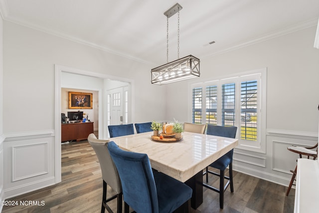 dining area with dark hardwood / wood-style floors and ornamental molding