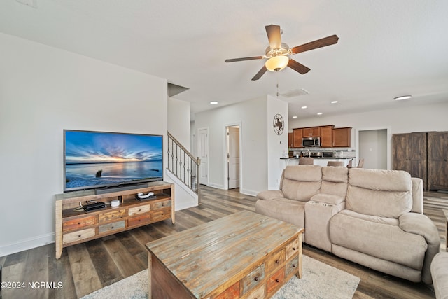 living room with ceiling fan and dark hardwood / wood-style floors