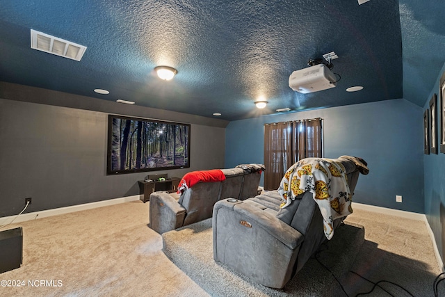 cinema room featuring a textured ceiling and carpet