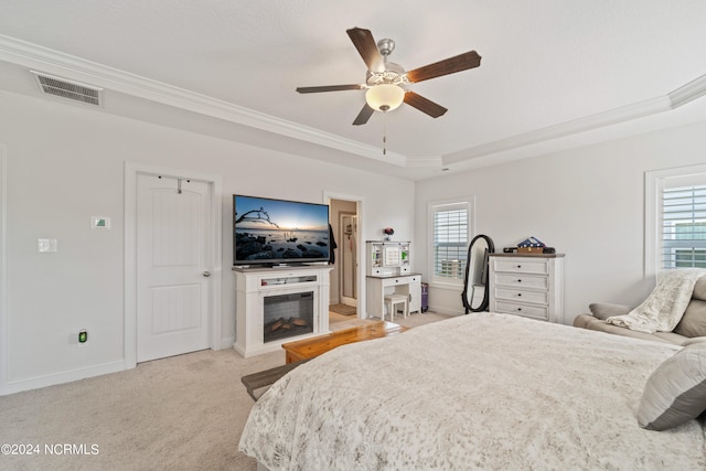 bedroom with ceiling fan, light colored carpet, crown molding, and multiple windows