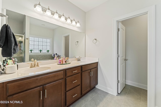 bathroom with tile patterned flooring and vanity