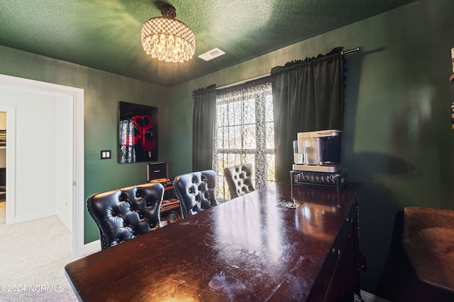 carpeted dining room with an inviting chandelier and a textured ceiling