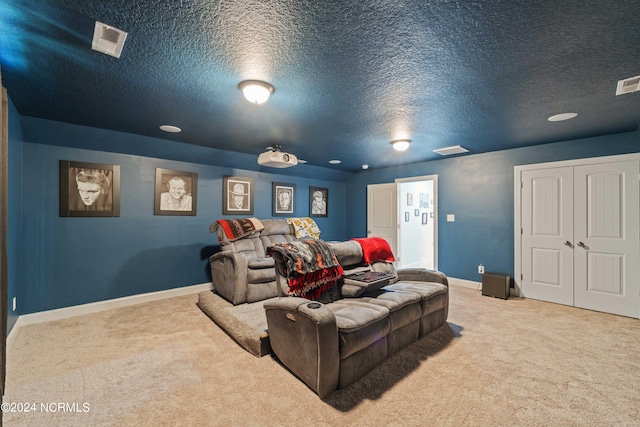 home theater room featuring a textured ceiling and carpet