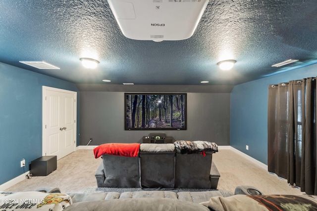 cinema featuring a textured ceiling and light carpet