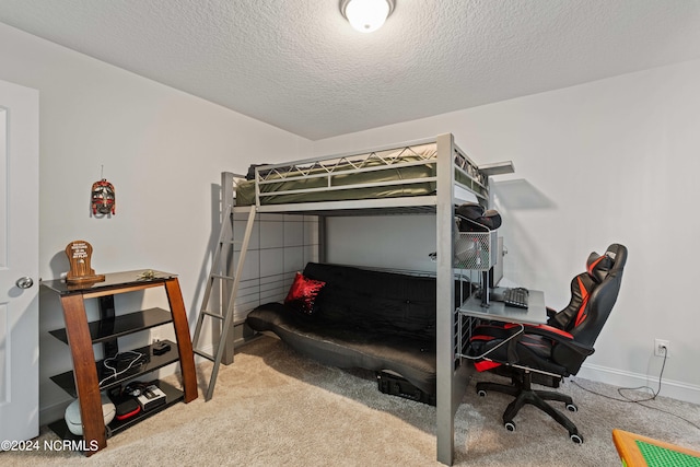 bedroom featuring carpet floors and a textured ceiling