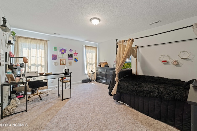 carpeted bedroom featuring a textured ceiling