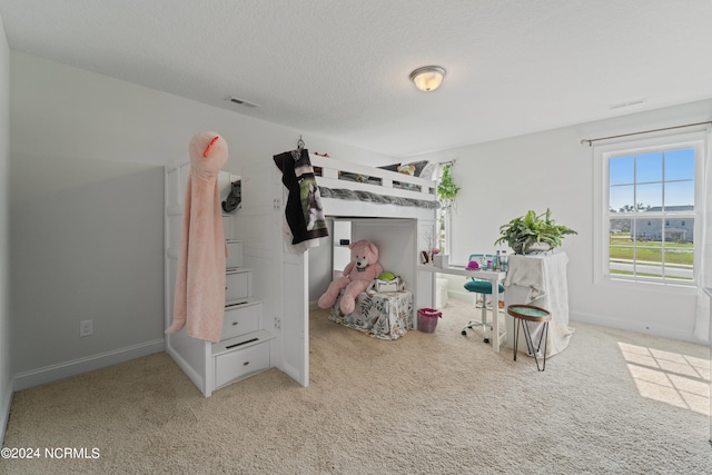 carpeted bedroom featuring a textured ceiling