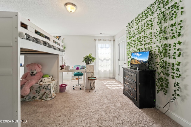 bedroom with a textured ceiling and carpet flooring