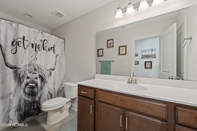 bathroom featuring tile patterned flooring, vanity, and toilet