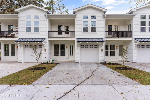 townhome / multi-family property featuring a garage and a balcony