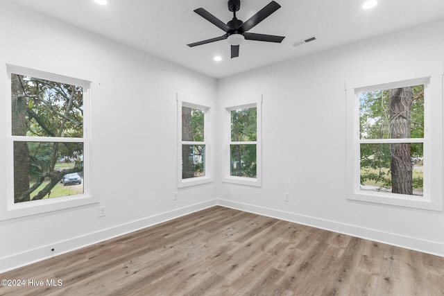 empty room featuring ceiling fan and hardwood / wood-style floors