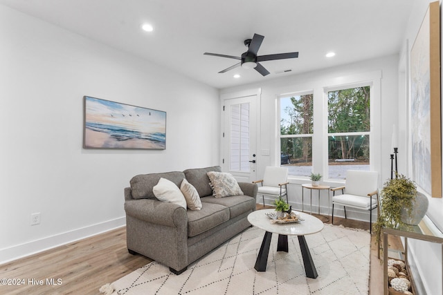 living room with light wood-type flooring and ceiling fan