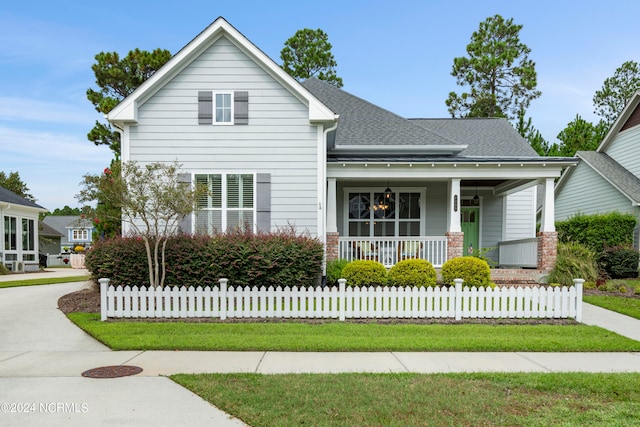 view of front of house featuring a front yard and covered porch