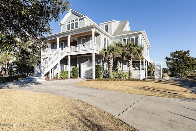 coastal home with a garage and a porch