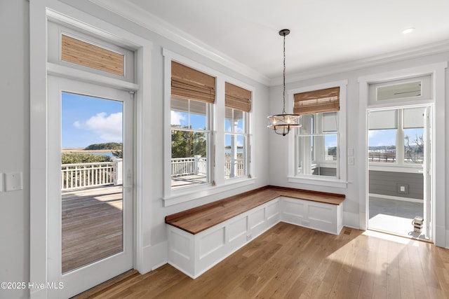 mudroom featuring a notable chandelier, ornamental molding, and light hardwood / wood-style floors