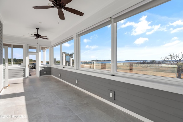 unfurnished sunroom featuring ceiling fan