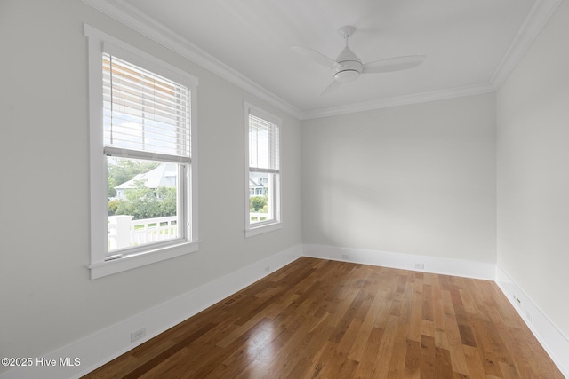 spare room with hardwood / wood-style floors, crown molding, and ceiling fan