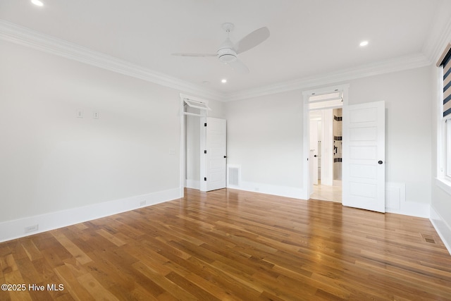 empty room featuring hardwood / wood-style flooring, ceiling fan, and ornamental molding