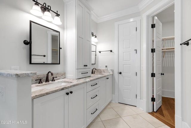 bathroom featuring tile patterned floors, ornamental molding, and vanity