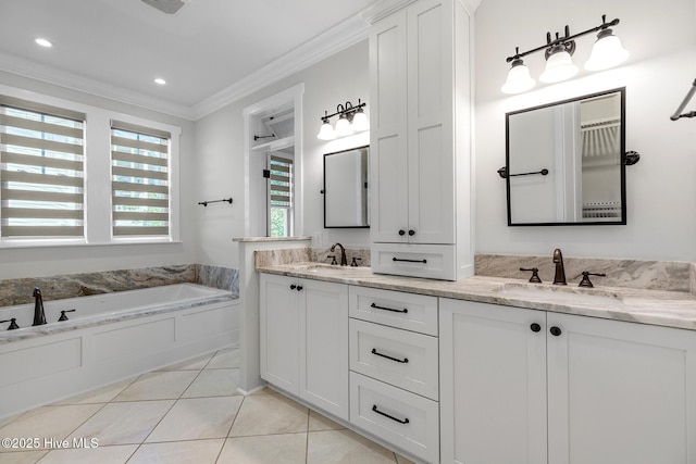 bathroom featuring vanity, a washtub, crown molding, and tile patterned floors