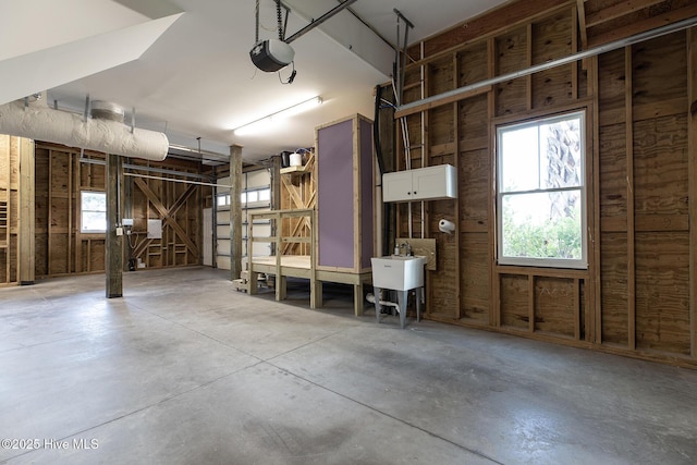 garage featuring a garage door opener and sink