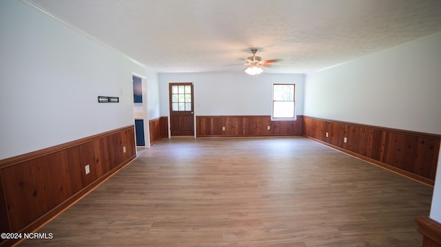 spare room with wood-type flooring, ceiling fan, and a wealth of natural light