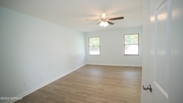 spare room featuring light hardwood / wood-style floors and ceiling fan