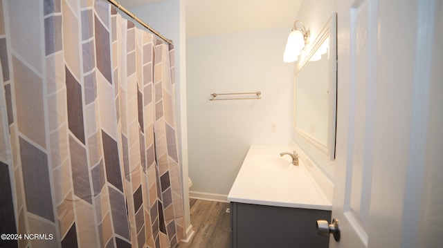 bathroom with wood-type flooring, vanity, toilet, and a shower with curtain