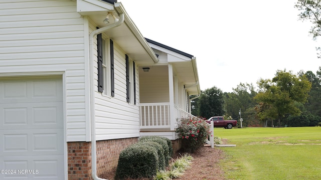 view of home's exterior with a yard and a garage