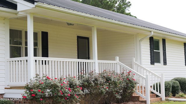 view of exterior entry featuring a porch