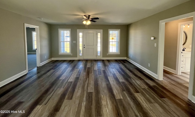 entrance foyer featuring dark wood-type flooring, ceiling fan, and baseboards