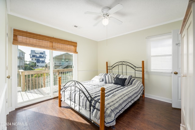 bedroom featuring ceiling fan, dark wood-type flooring, access to exterior, and multiple windows