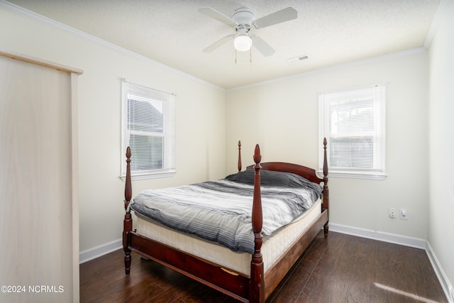 bedroom with ornamental molding, ceiling fan, dark wood-type flooring, and a textured ceiling