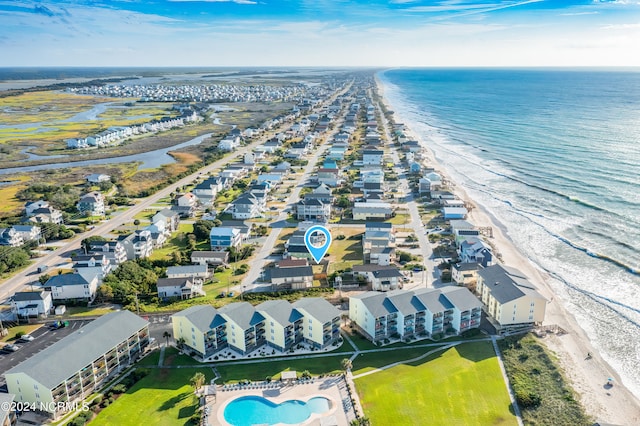 bird's eye view with a water view and a beach view